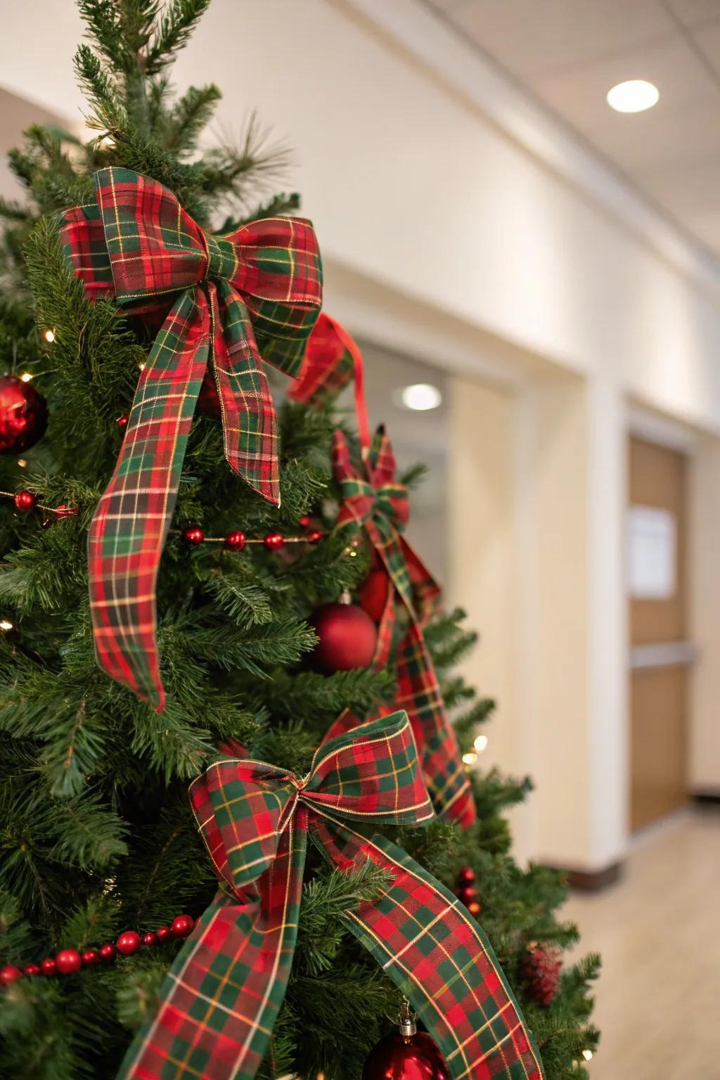 A traditional tartan-themed Christmas tree featuring red and green accents.