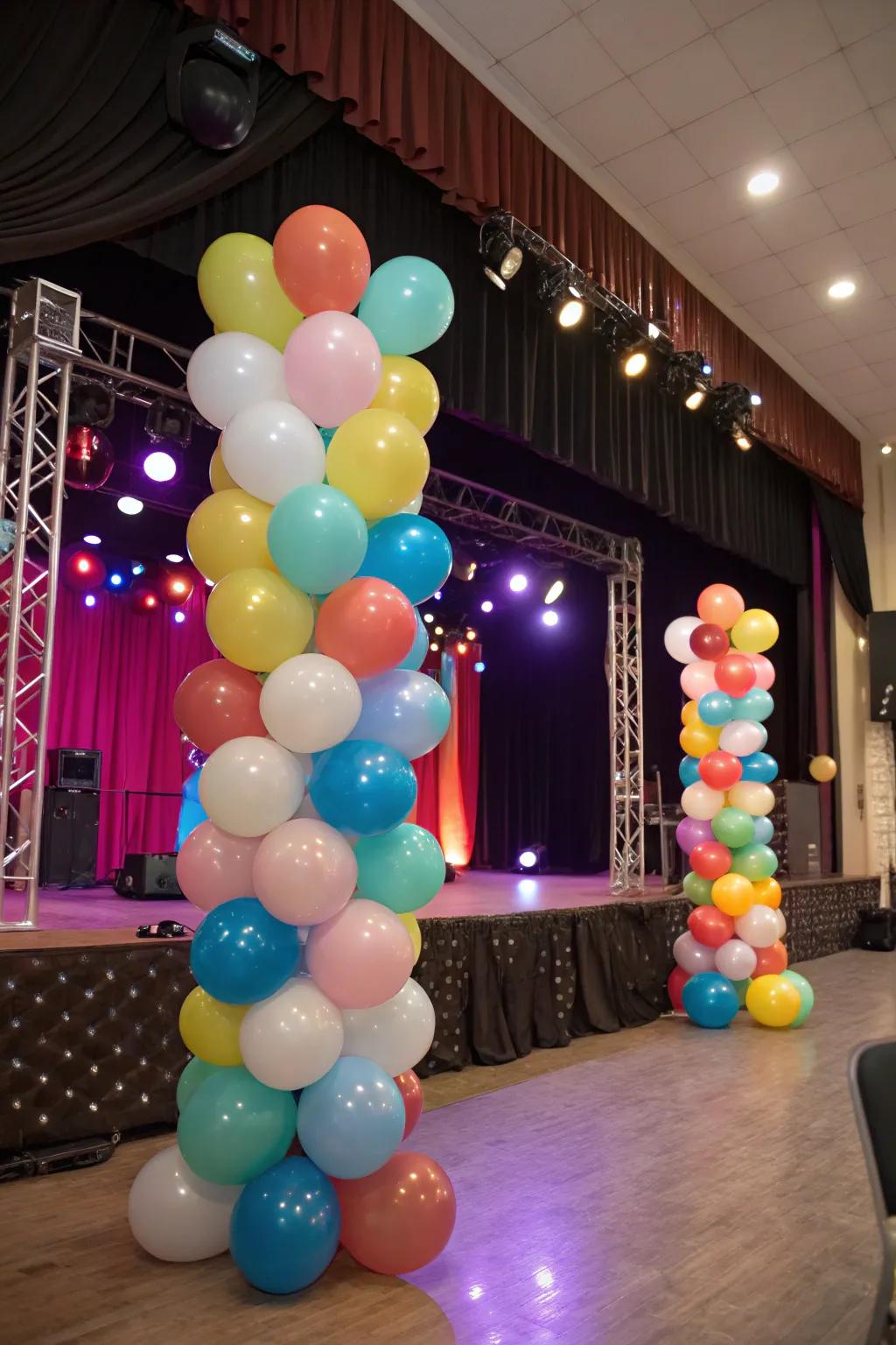 A vibrant stage setup with balloons of varying sizes and colors.