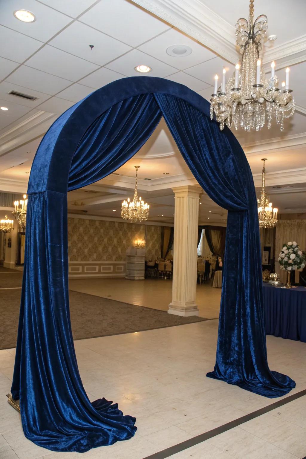 An elegant arch that uses luxurious velvet drapery to create a dramatic effect.