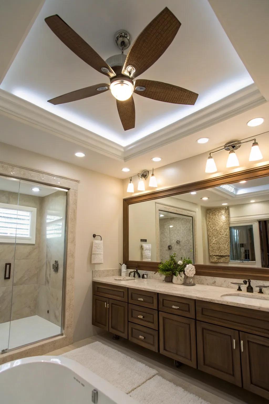A sophisticated bathroom showcasing a fan featuring inset lighting.