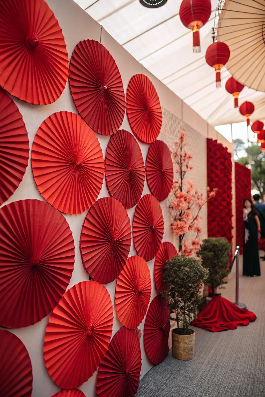 A creative scarlet paper rosette wall backdrop for memorable photos.