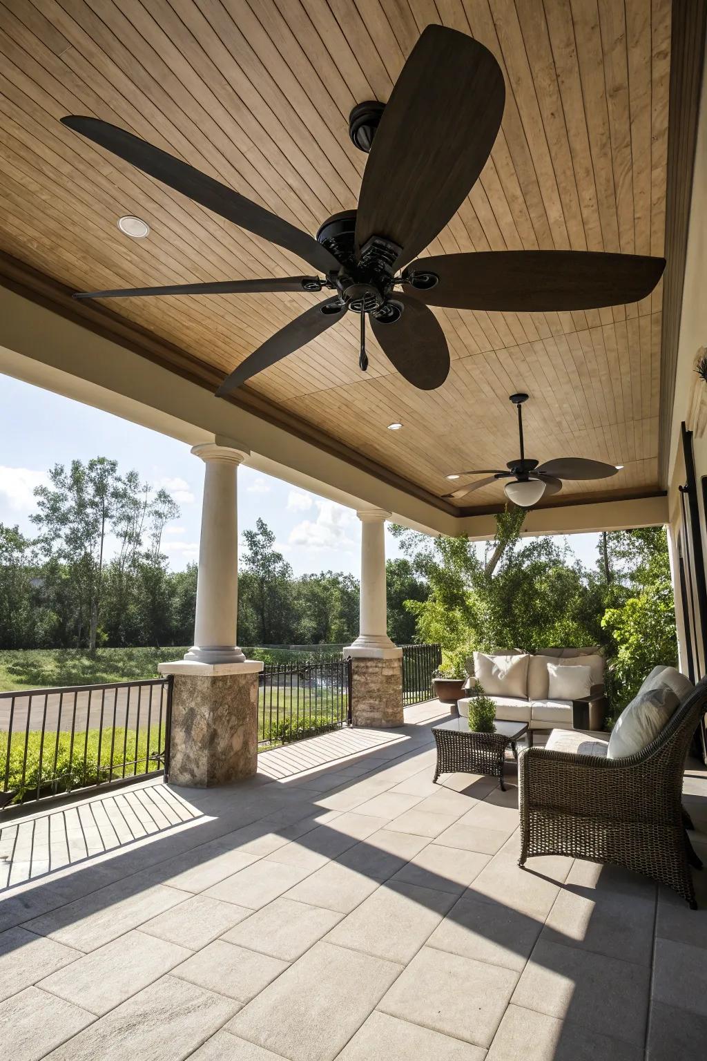 A spacious deck highlighted by a ceiling fan with oversized blades.