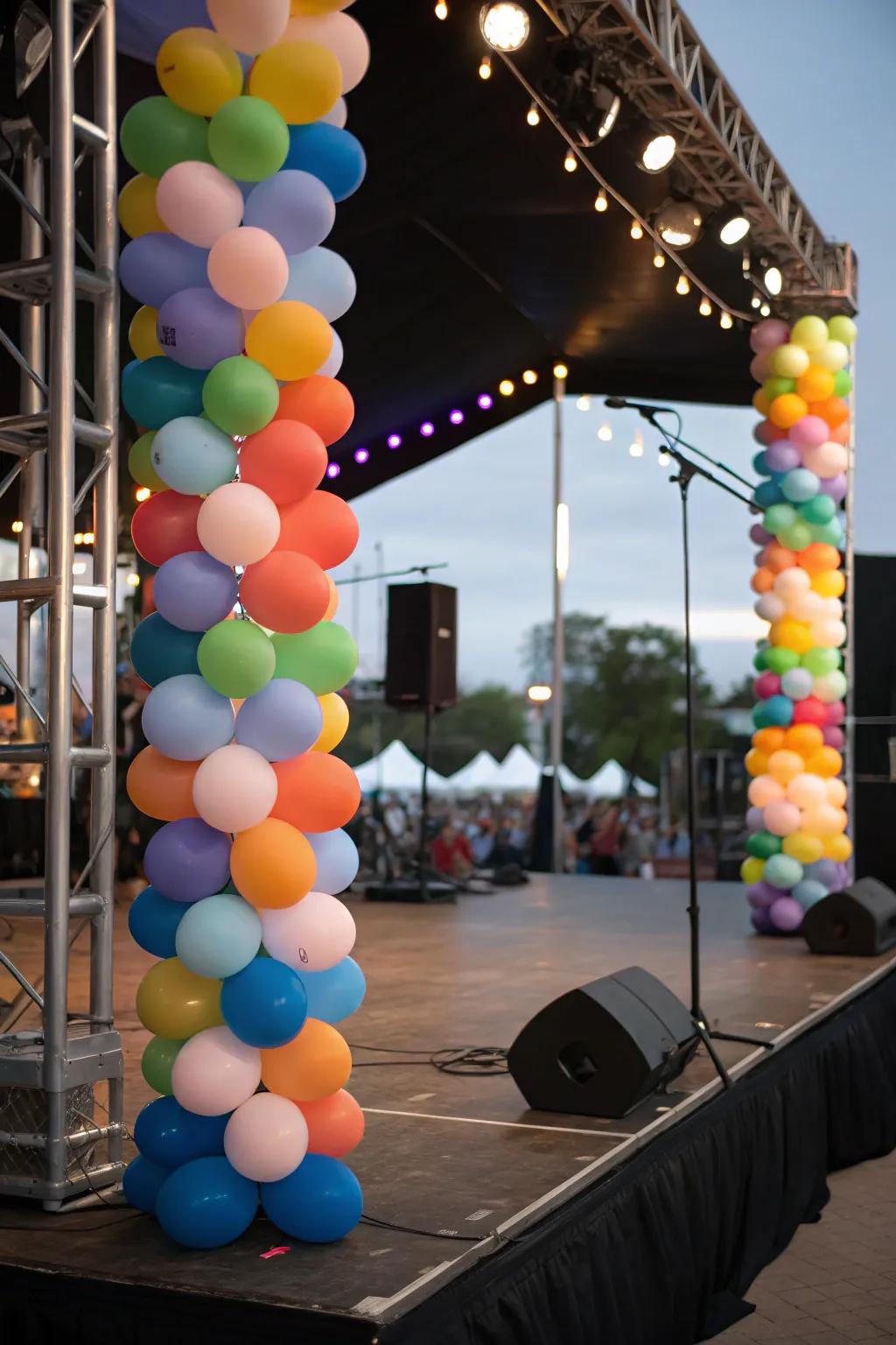 Balloon columns framing the performance area on stage.